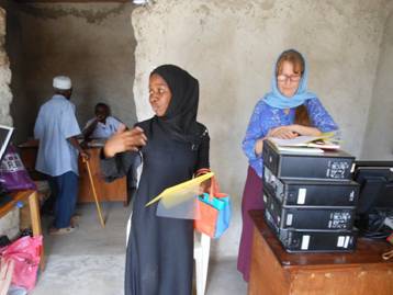 Hawa and Lisa explain the program to the first agents in the Chairman's office